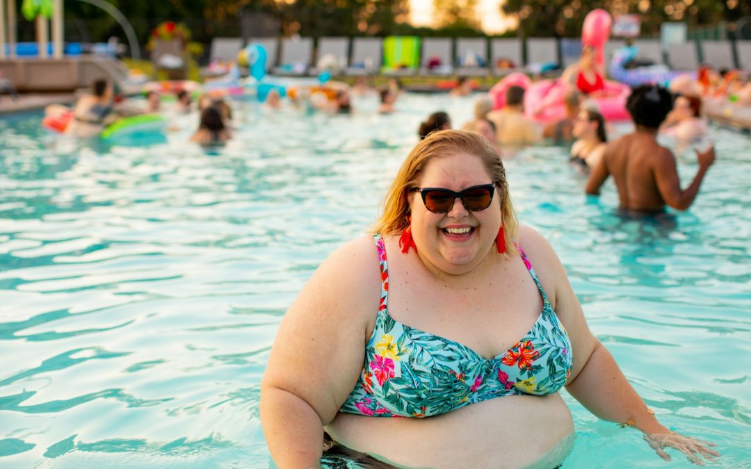 woman wearing blue and red floral bikini top on pool